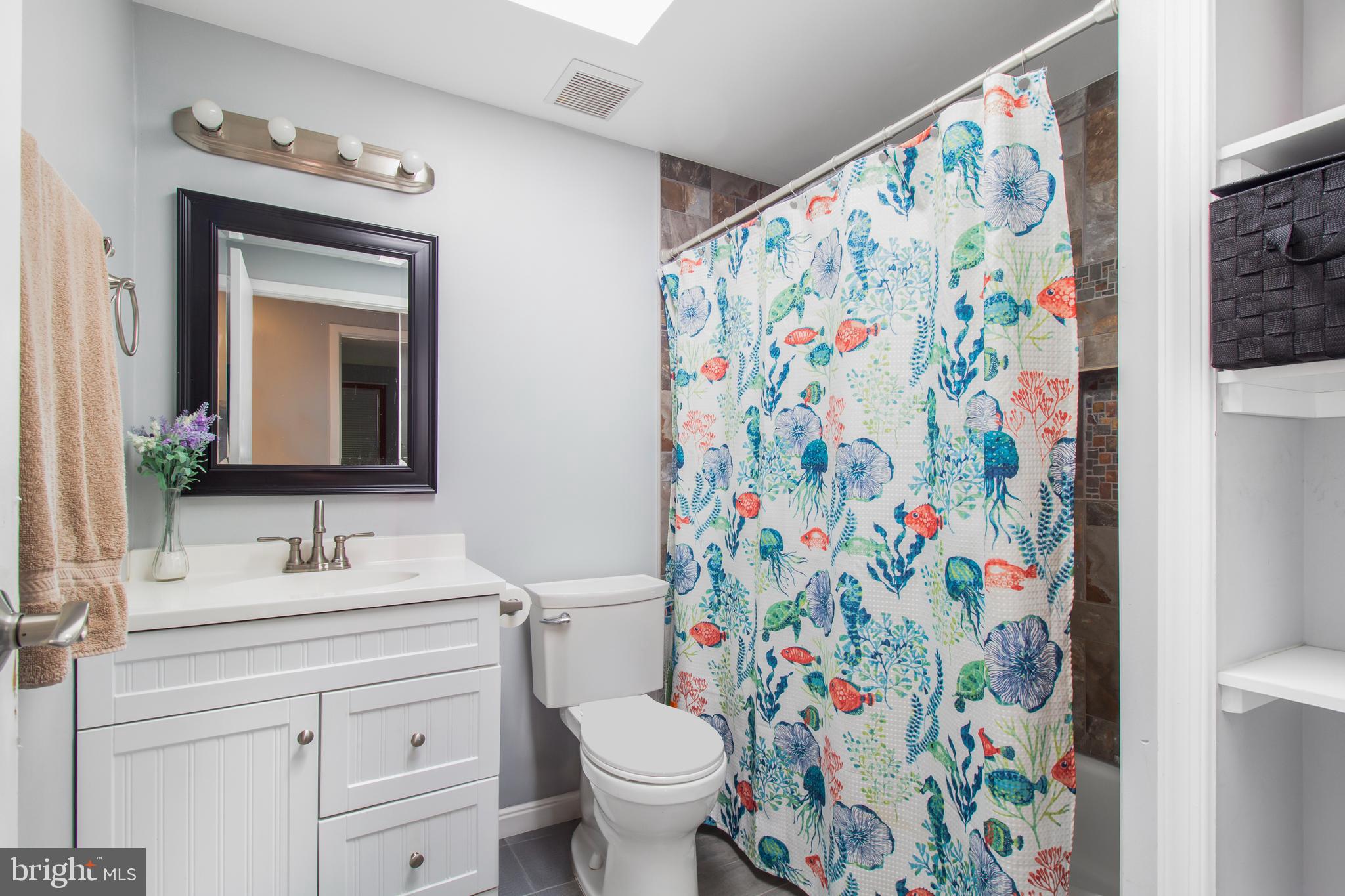 7009 Deepage Drive Columbia, MD 21045 - Photo 13 of 34 a bathroom with a sink toilet and a mirror