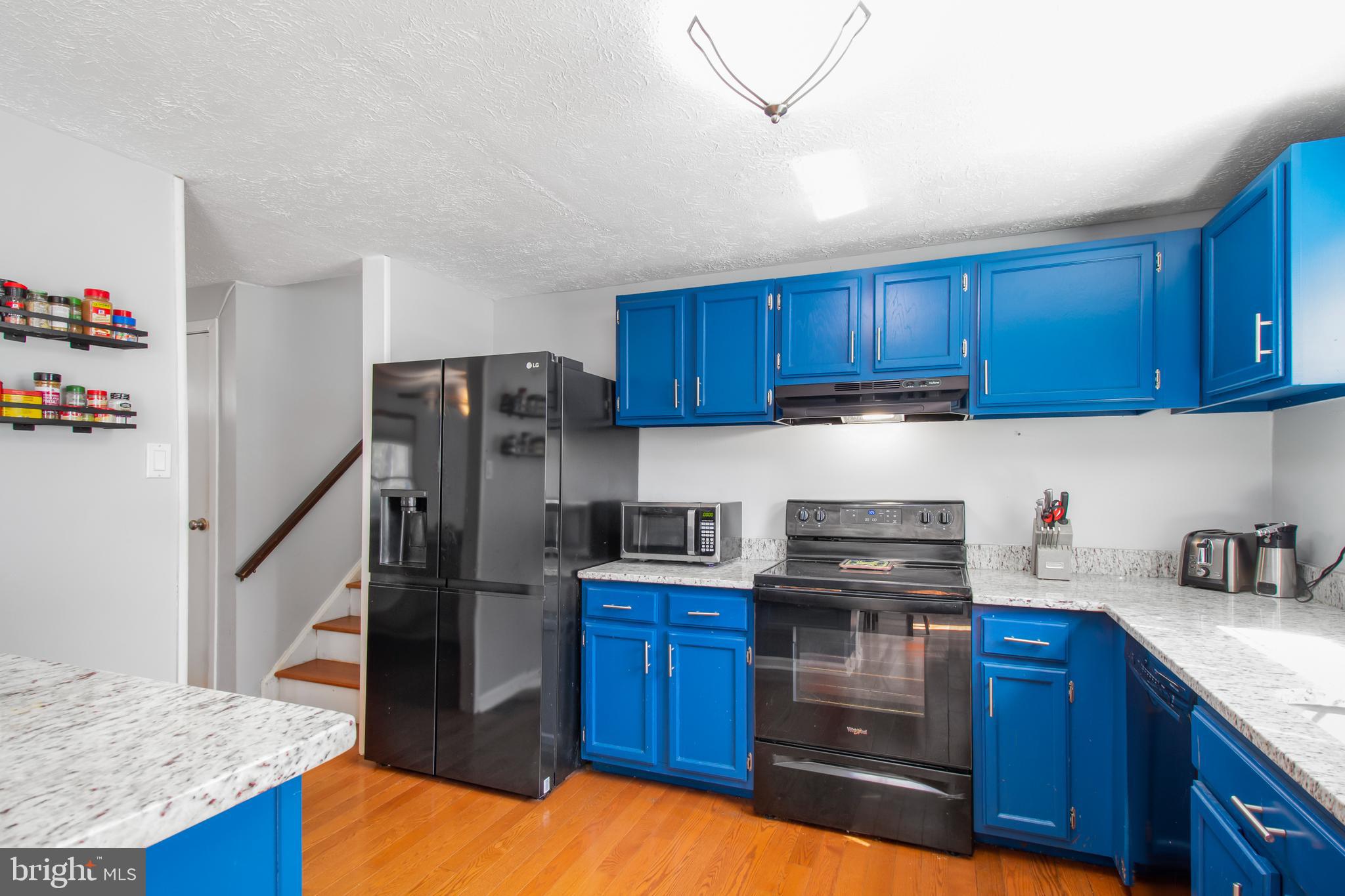 7009 Deepage Drive Columbia, MD 21045 - Photo 4 of 34 a kitchen with refrigerator and cabinets