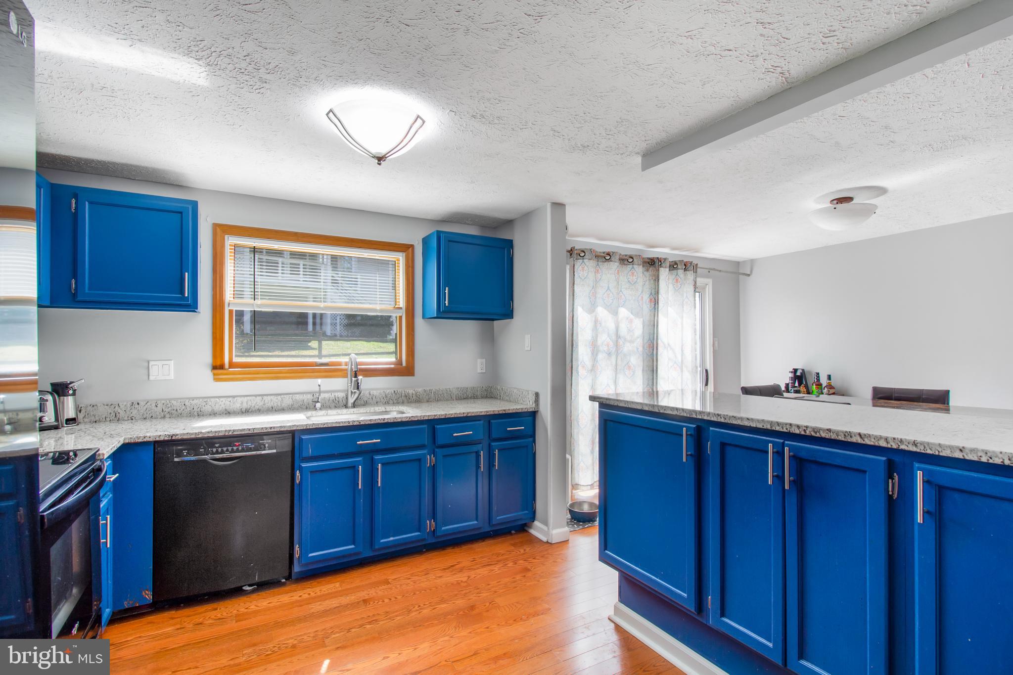 7009 Deepage Drive Columbia, MD 21045 - Photo 5 of 34 a kitchen with stainless steel appliances granite countertop wooden cabinets sink and window