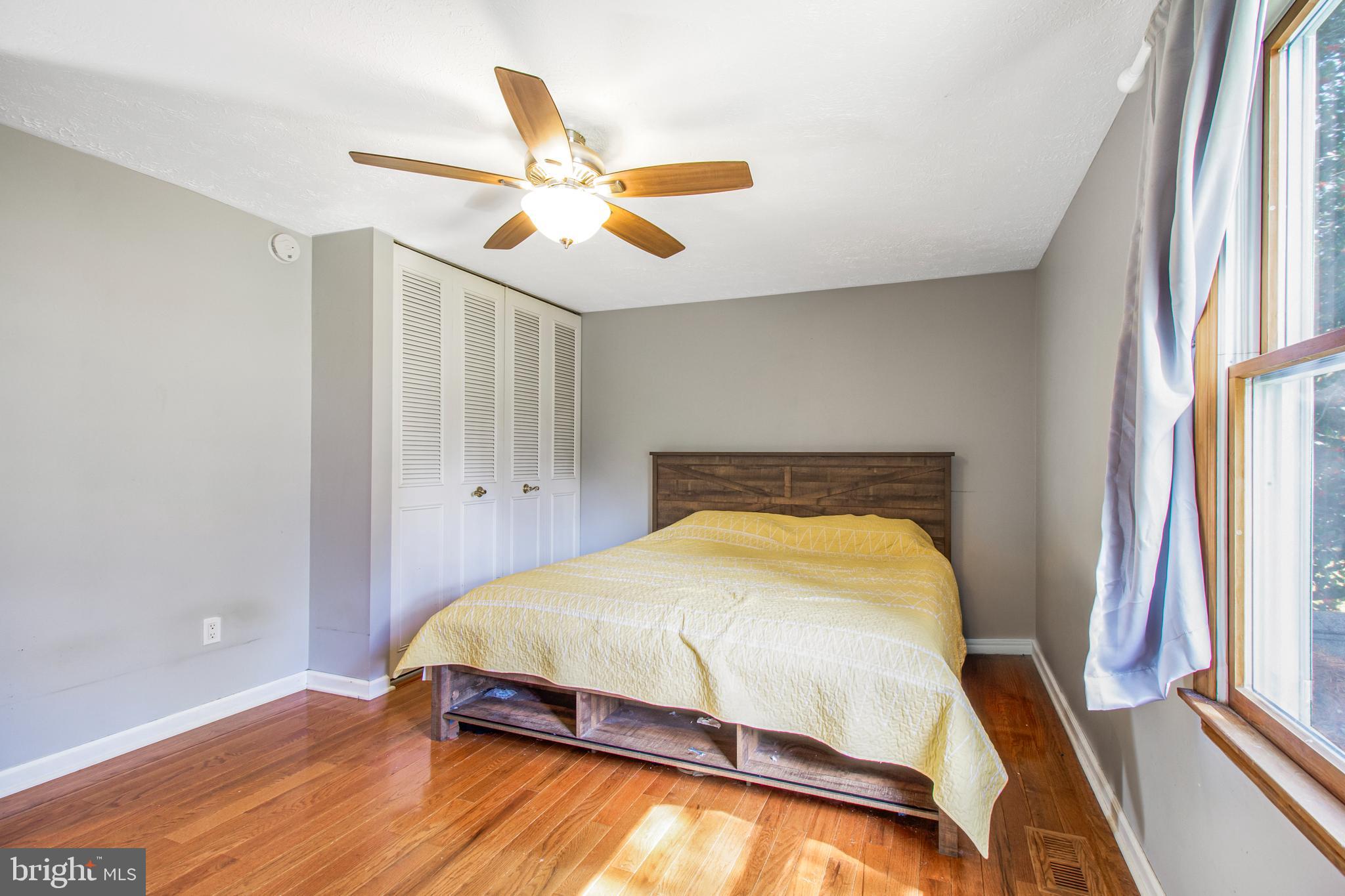 7009 Deepage Drive Columbia, MD 21045 - Photo 9 of 34 a bedroom with a bed and wooden floor