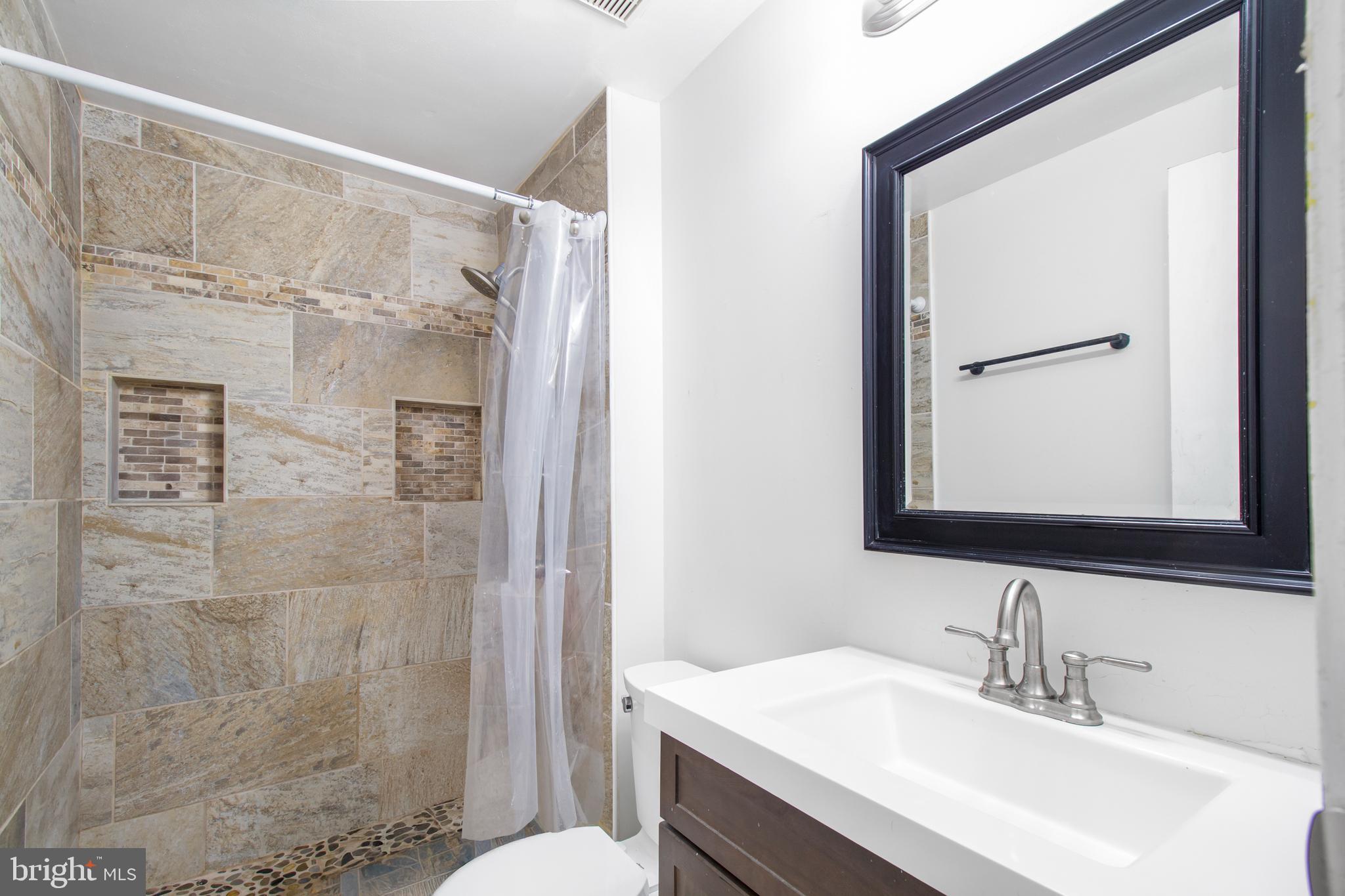 7009 Deepage Drive Columbia, MD 21045 - Photo 10 of 34 a bathroom with a sink and a mirror