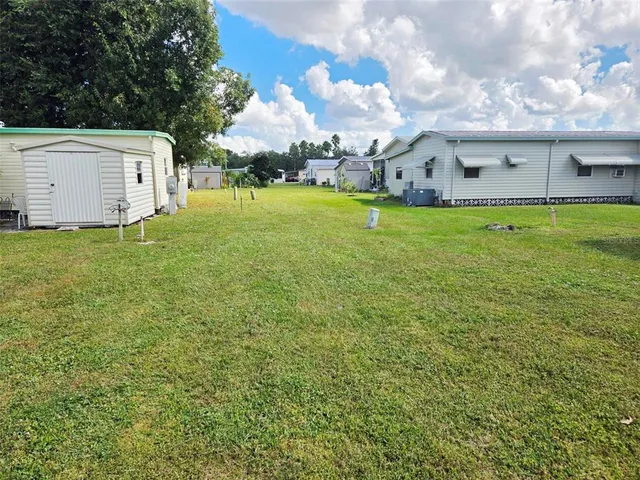 a living room with furniture a flat screen tv and a refrigerator