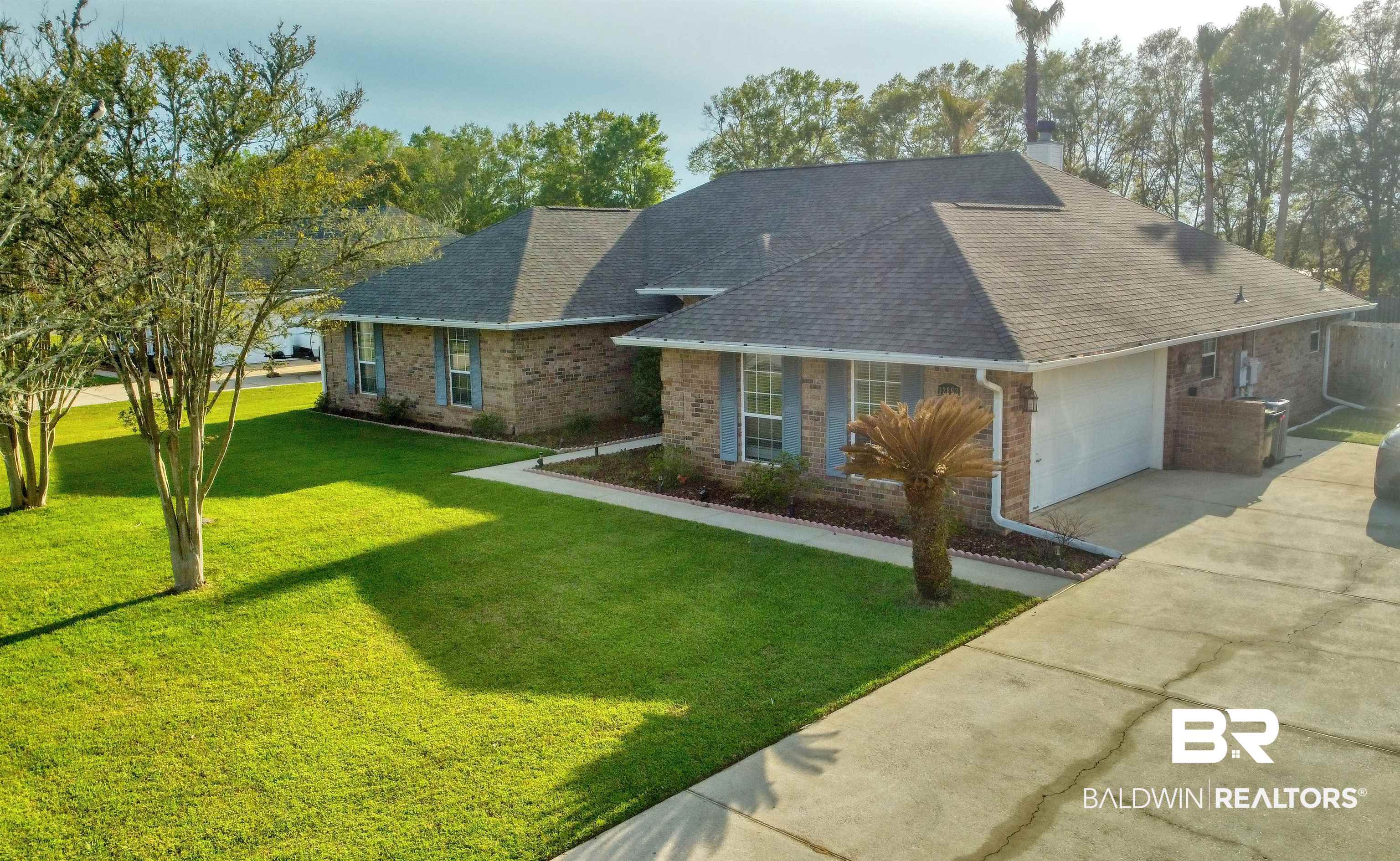 12893 Hunters Chase Foley, AL 36535 - Photo 1 of 42 Single story home featuring an attached garage, concrete driveway, brick siding, a front lawn, and a shingled roof