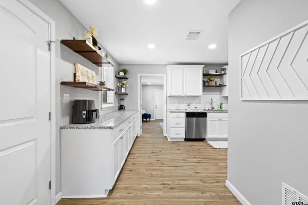 a large kitchen with stainless steel appliances granite countertop a stove and a sink