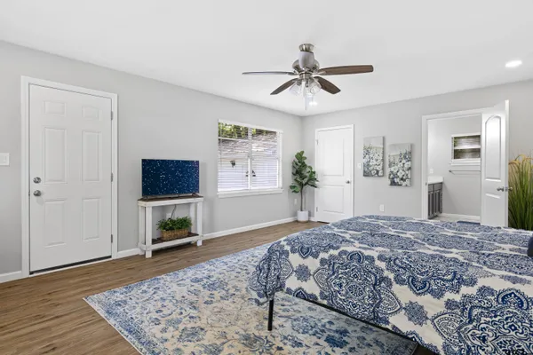 a bedroom with a bed and a flat screen tv