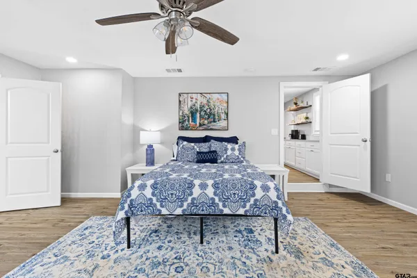 a bed room with a bed and painting on the wall