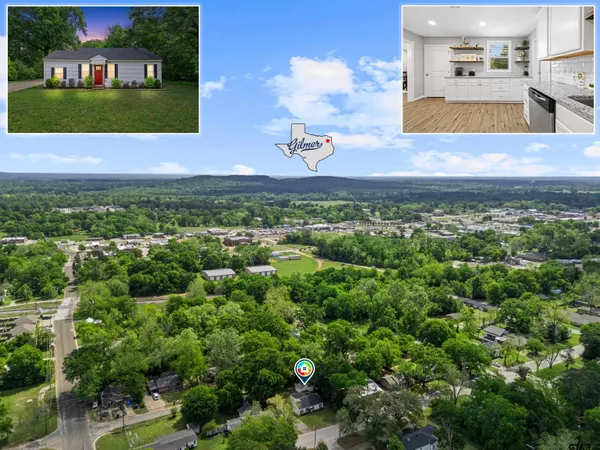 an aerial view of a house with a yard and lake view