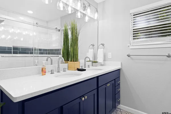 a bathroom with a sink double vanity and a mirror