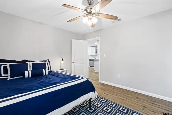 a bedroom with a bed and a chandelier