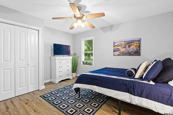 a bedroom with a bed and wooden floor