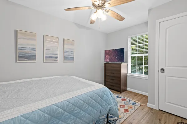 a bedroom with a bed and a window