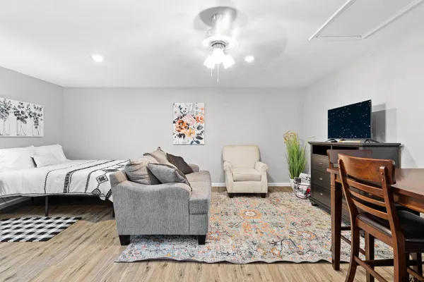 a bedroom with furniture and a flat screen tv
