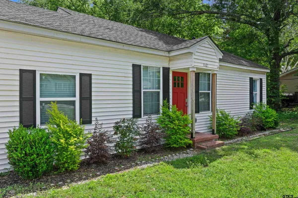 a front view of a house with a garden