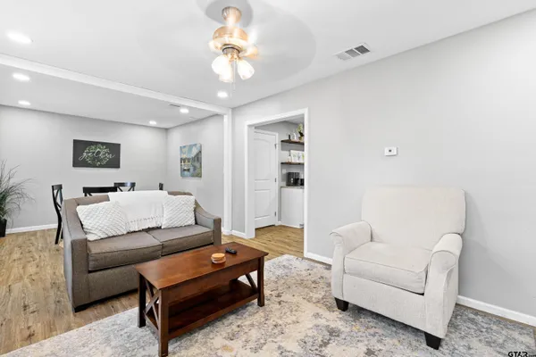 a living room with furniture and a chandelier