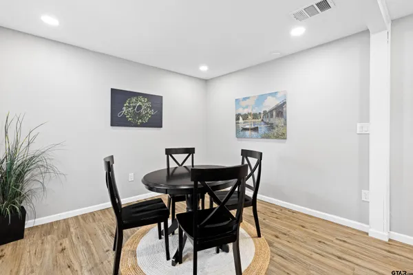 a view of a dining room with furniture and wooden floor