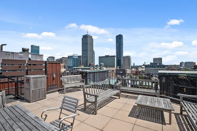 a view of a terrace with wooden benches