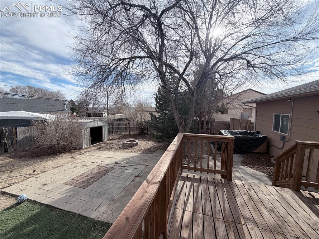 38 Macalester Road Pueblo, CO 81001 - Photo 14 of 15 a view of a roof deck with table and chairs under an umbrella with wooden floor