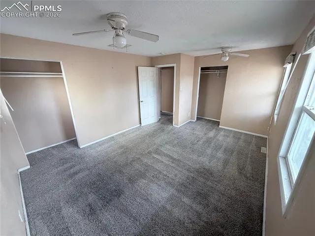 a view of empty room with ceiling fan