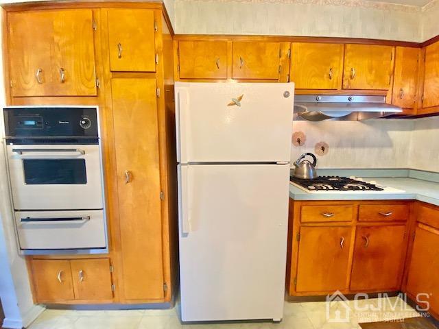 30 Main Street East Brunswick, NJ 08816 - Photo 17 of 40 a white refrigerator freezer and a stove sitting inside of a kitchen