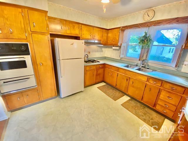 30 Main Street East Brunswick, NJ 08816 - Photo 18 of 40 a kitchen with stainless steel appliances a refrigerator sink and cabinets