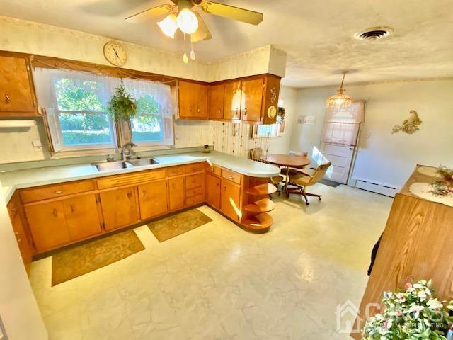 30 Main Street East Brunswick, NJ 08816 - Photo 19 of 40 a view of a kitchen with a sink and dishwasher a dining table chairs with wooden floor