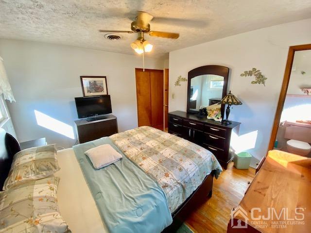 30 Main Street East Brunswick, NJ 08816 - Photo 21 of 40 a bedroom with a bed and a chandelier