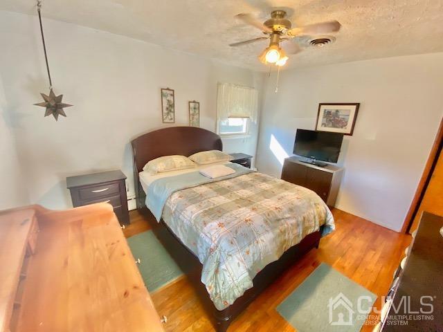 30 Main Street East Brunswick, NJ 08816 - Photo 22 of 40 a bedroom with a bed and a chandelier