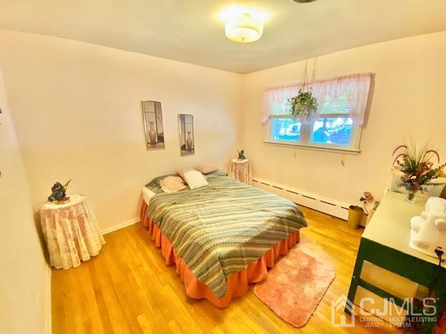 30 Main Street East Brunswick, NJ 08816 - Photo 25 of 40 a bedroom with a bed and painting on the wall