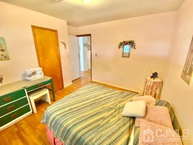 30 Main Street East Brunswick, NJ 08816 - Photo 26 of 40 a bedroom with a bed and wooden floor