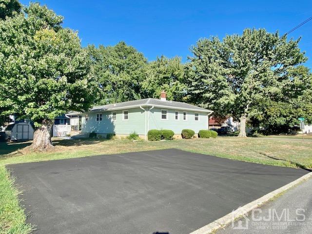 30 Main Street East Brunswick, NJ 08816 - Photo 4 of 40 a front view of a house with a yard and garage