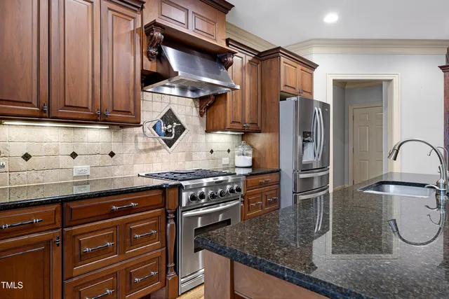 a view of kitchen with stainless steel appliances cabinets and a window