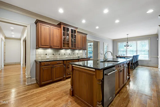 a spacious bathroom with a double vanity sink a mirror and a bathtub