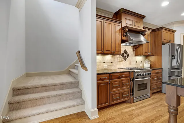 a view of a hallway with wooden floor and windows