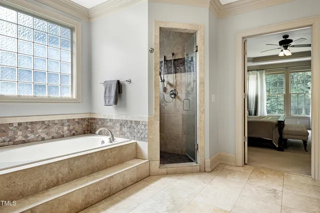 a living room with furniture a ceiling fan and a flat screen tv