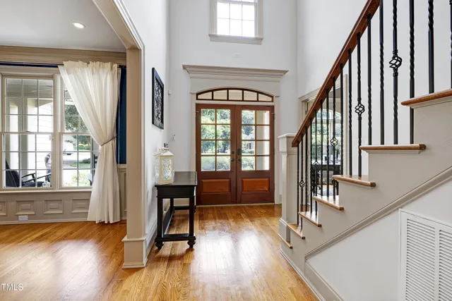 a dining room with furniture a chandelier and wooden floor