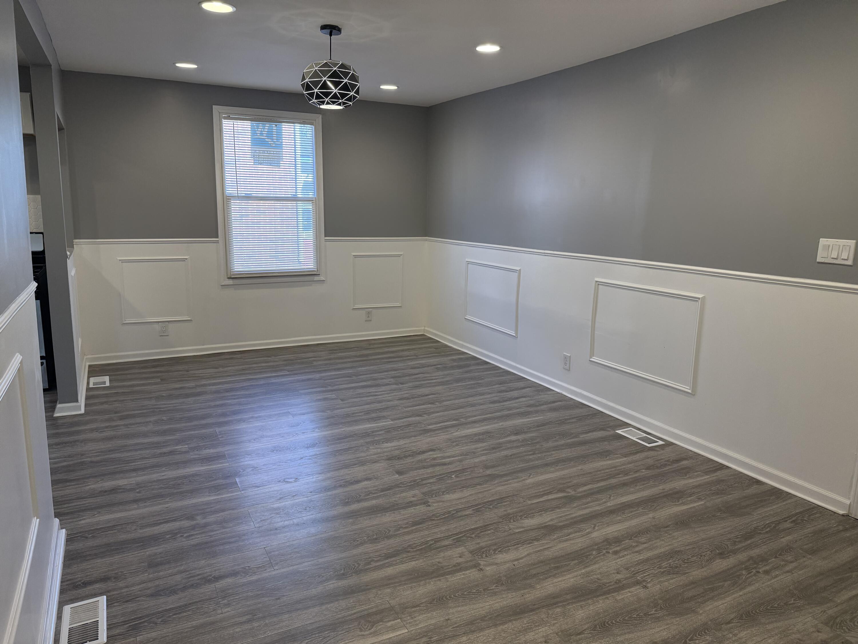 634 Kentucky Street Gary, IN 46402 - Photo 5 of 18 an empty room with wooden floor and windows