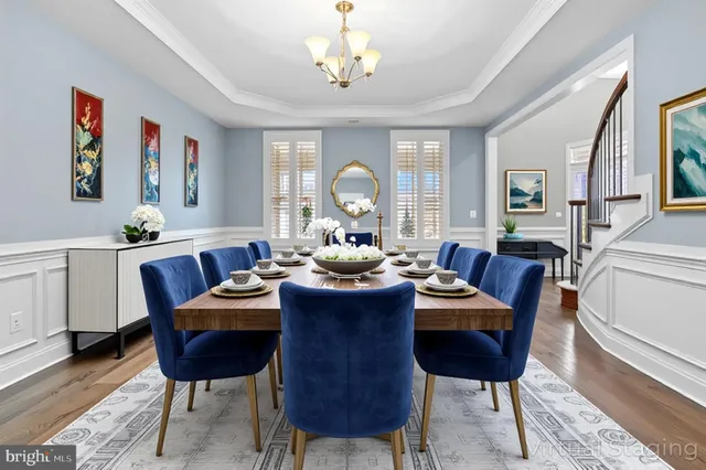 a kitchen with stainless steel appliances kitchen island granite countertop a refrigerator a sink dishwasher a stove and white cabinets with wooden floor