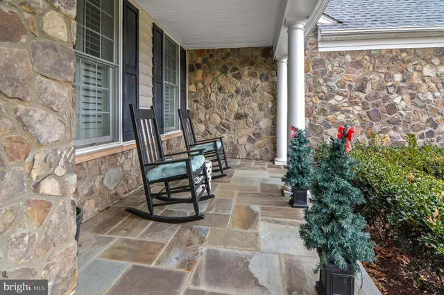 a view of a patio with table and chairs and potted plants