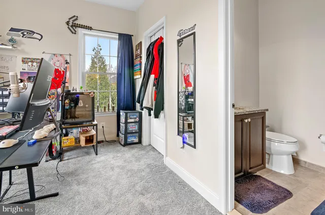 a living room with furniture a wooden floor and next to a window