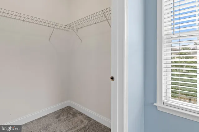 a bedroom with a bed a couch and a chandelier