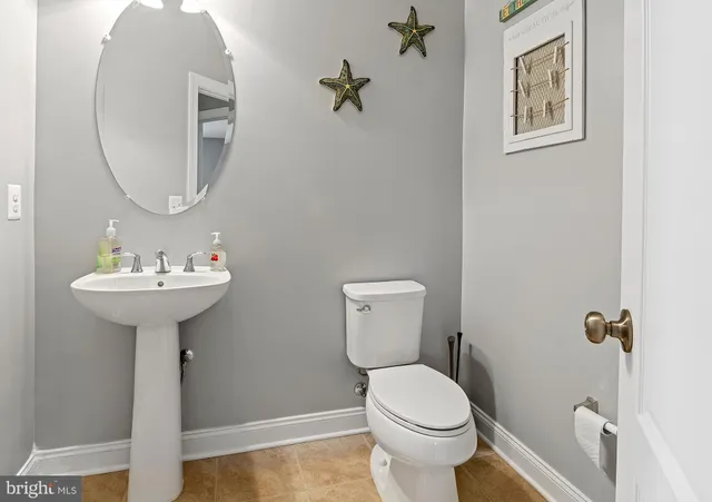 a green field with lots of trees in the background