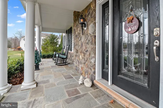 a view of a living room with wooden floor and stairs