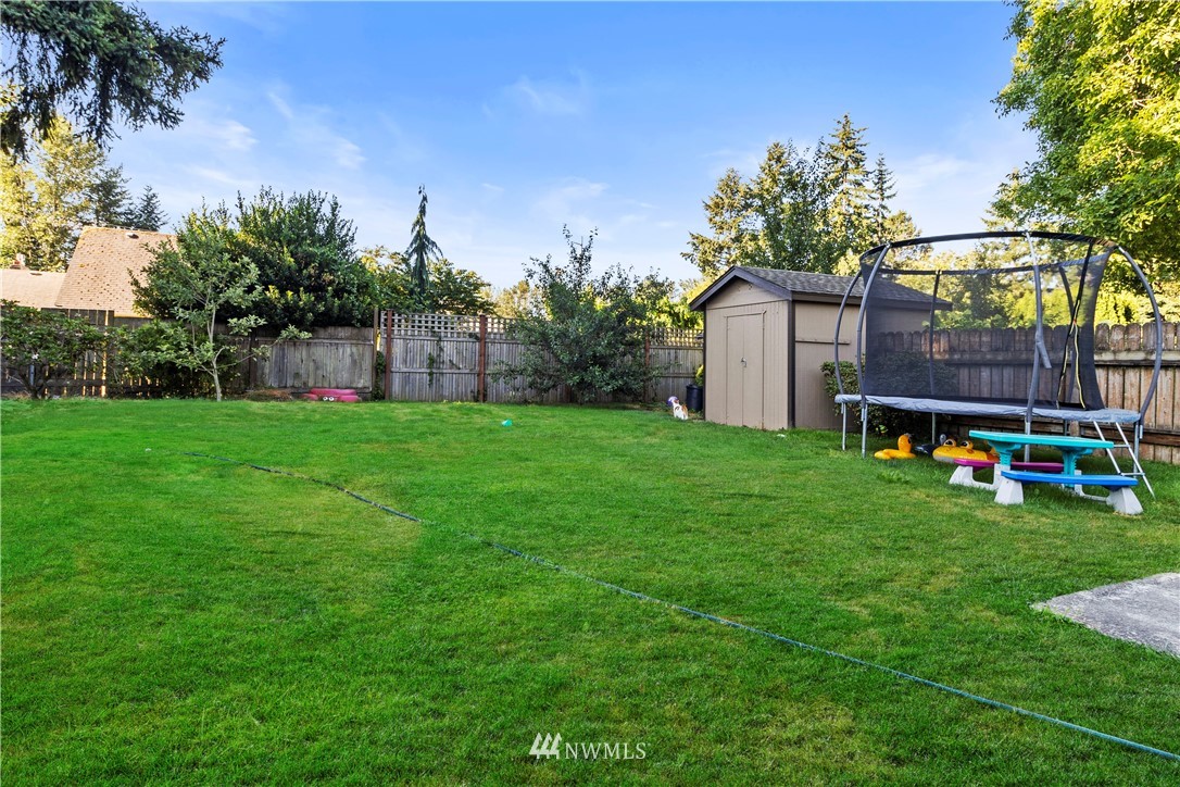 412 State Street, Unit A & B Sumner, WA 98390 - Photo 22 of 23 a house with garden in front of it