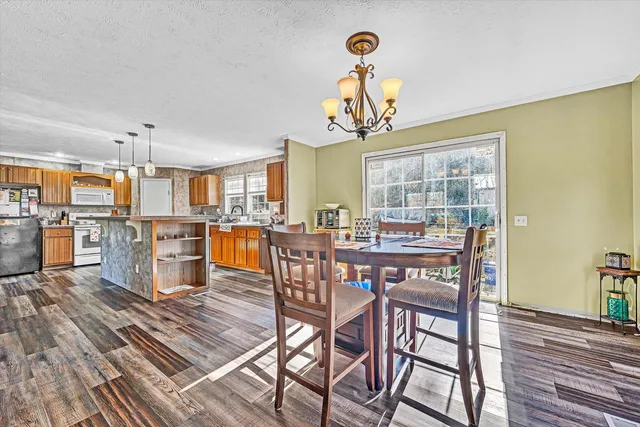 a kitchen with stainless steel appliances granite countertop sink stove and refrigerator