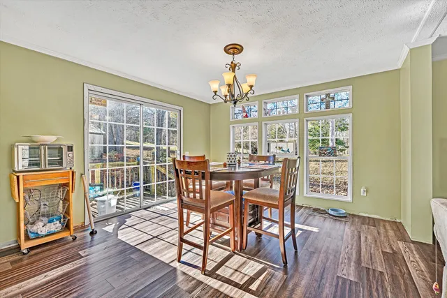 a view of a kitchen with cabinets and wooden floor