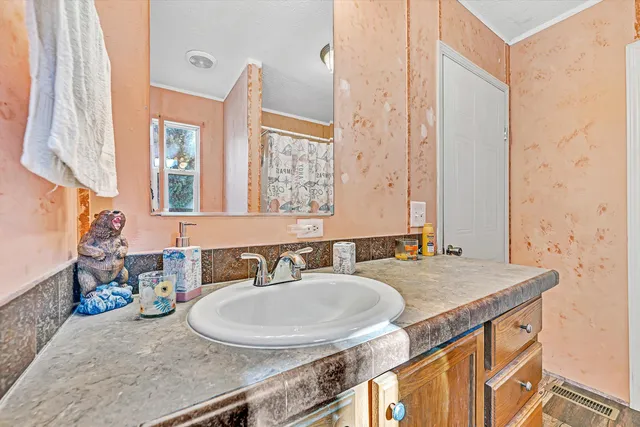 a bathroom with a double vanity sink toilet and a tub