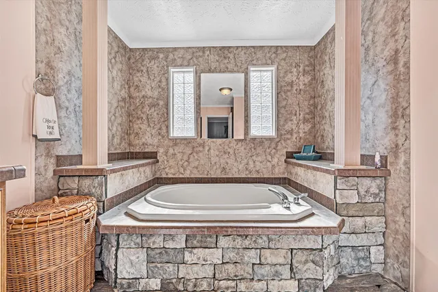a view of a house with backyard and wooden fence