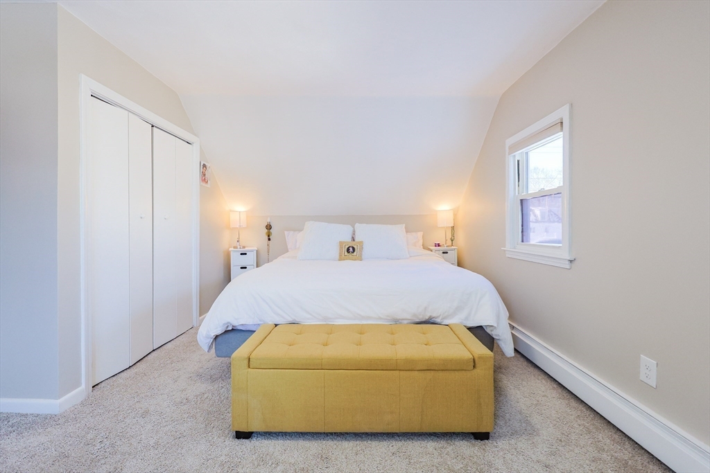 158 Chester Street Worcester, MA 01605 - Photo 23 of 42 a spacious bedroom with a bed and window