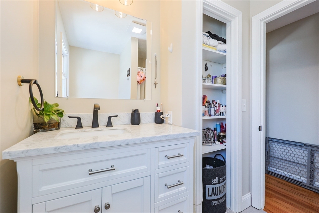 158 Chester Street Worcester, MA 01605 - Photo 29 of 42 a bathroom with a granite countertop sink and a mirror