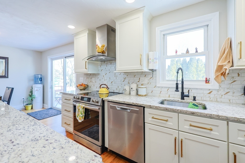 158 Chester Street Worcester, MA 01605 - Photo 9 of 42 a kitchen with stainless steel appliances granite countertop a sink a stove and a window